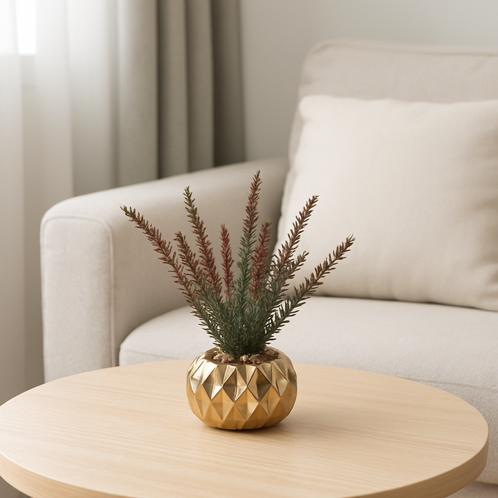 Small artificial plant in a gold porcelain pot