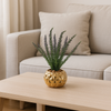 Small artificial plant in a gold porcelain pot