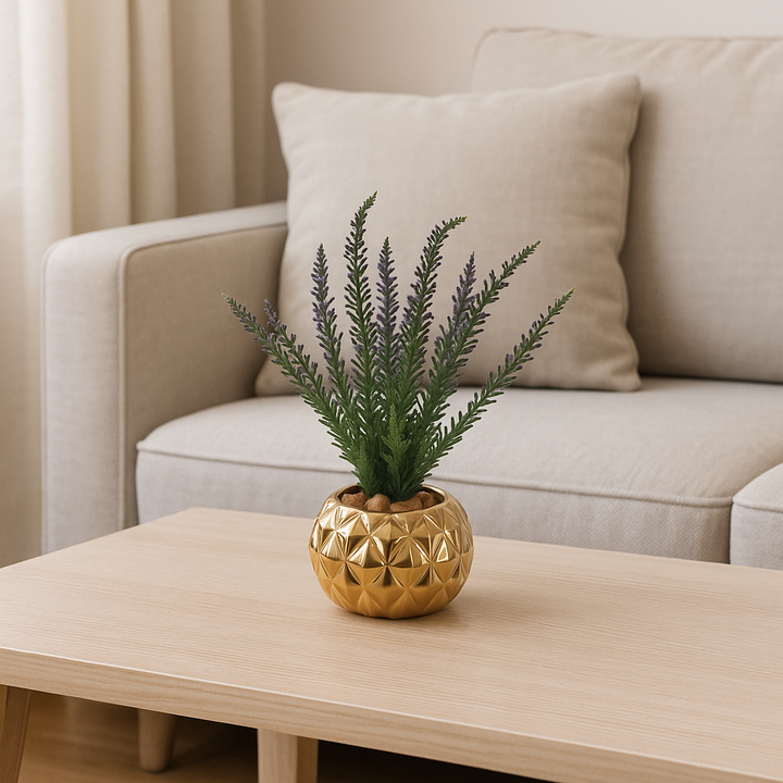 Small artificial plant in a gold porcelain pot