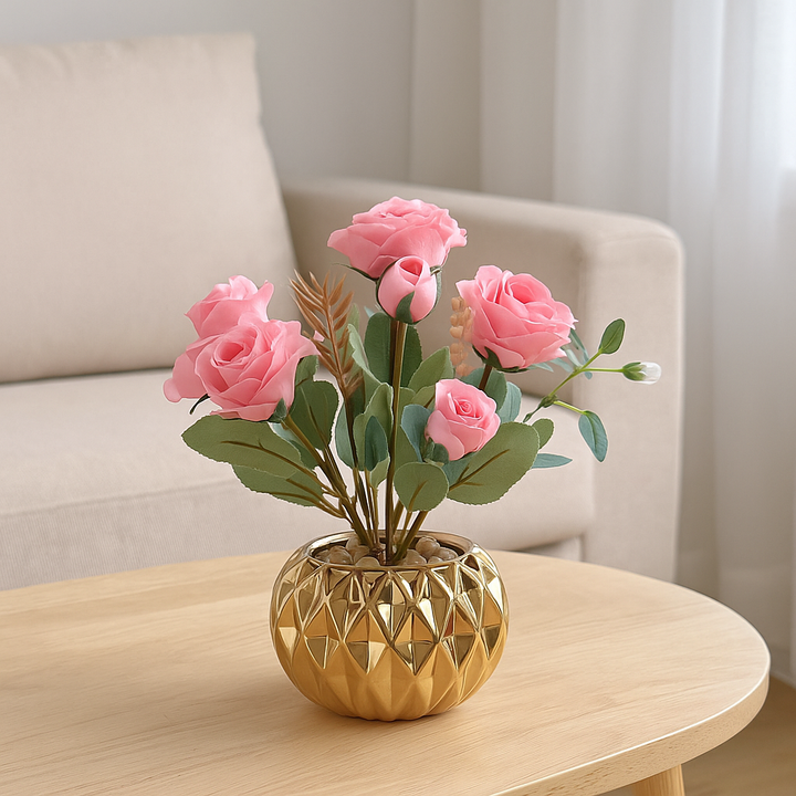 Pink artificial roses in a gold porcelain pot