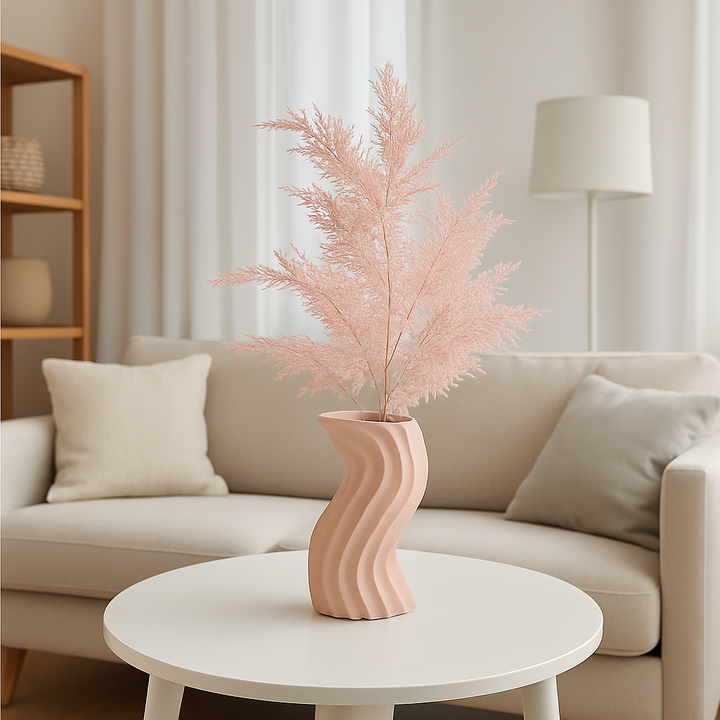 Pink artificial branches in a pink ceramic vase