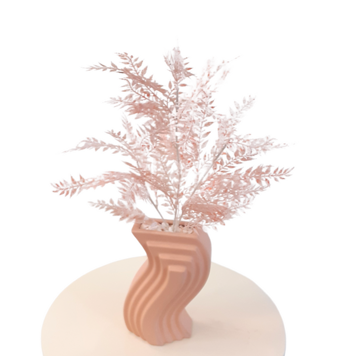 Pink artificial branches in a pink ceramic vase