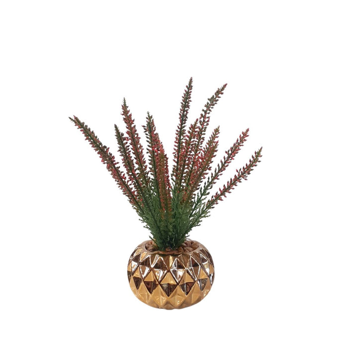 Small artificial plant in a gold porcelain pot