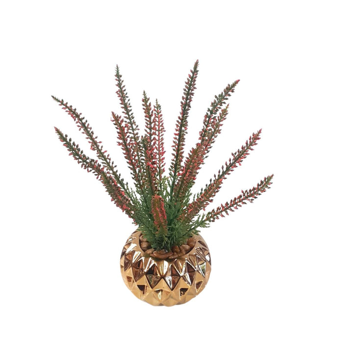 Small artificial plant in a gold porcelain pot