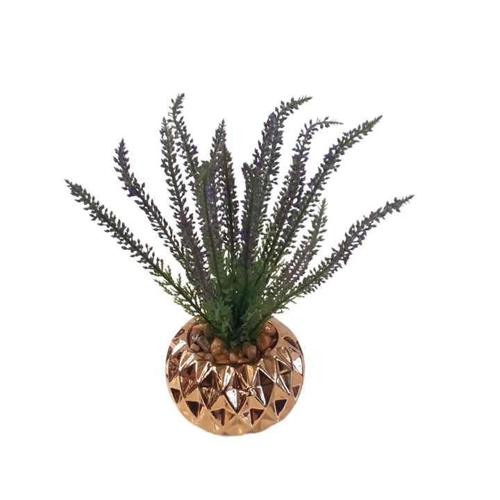 Small artificial plant in a gold porcelain pot