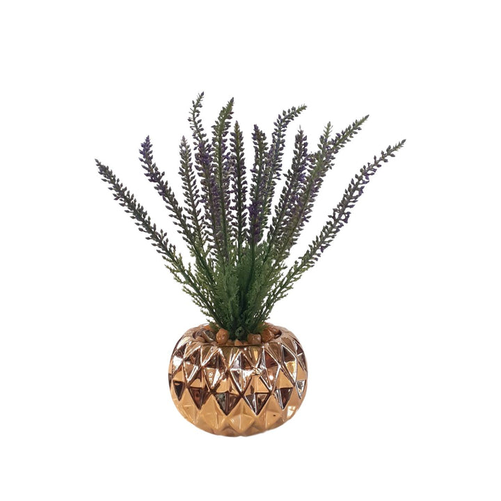 Small artificial plant in a gold porcelain pot
