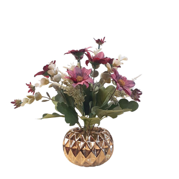 Various artificial flower arrangements in a golden porcelain pot