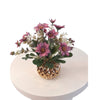 Various artificial flower arrangements in a golden porcelain pot