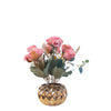 Pink artificial roses in a gold porcelain pot
