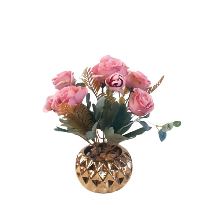 Pink artificial roses in a gold porcelain pot