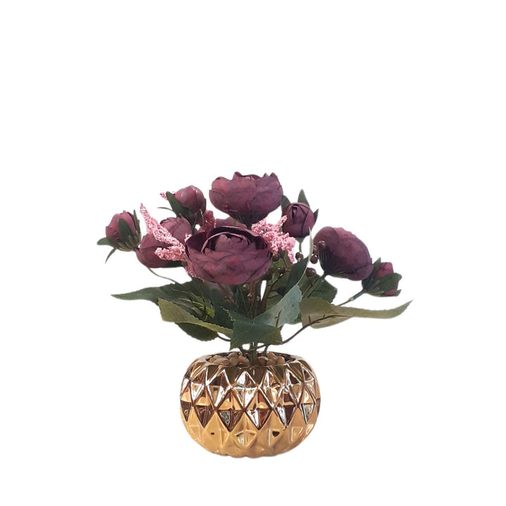 Burgundy artificial roses in a gold porcelain pot