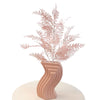 Pink artificial branches in a pink ceramic vase